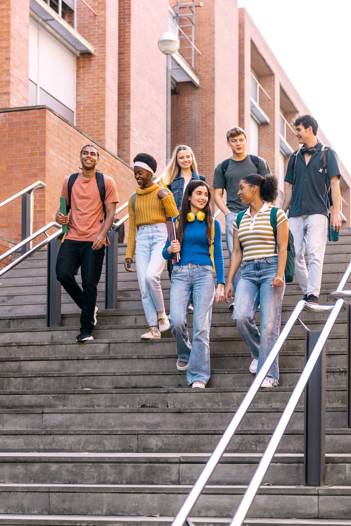 A diverse group of young people standing together outside.