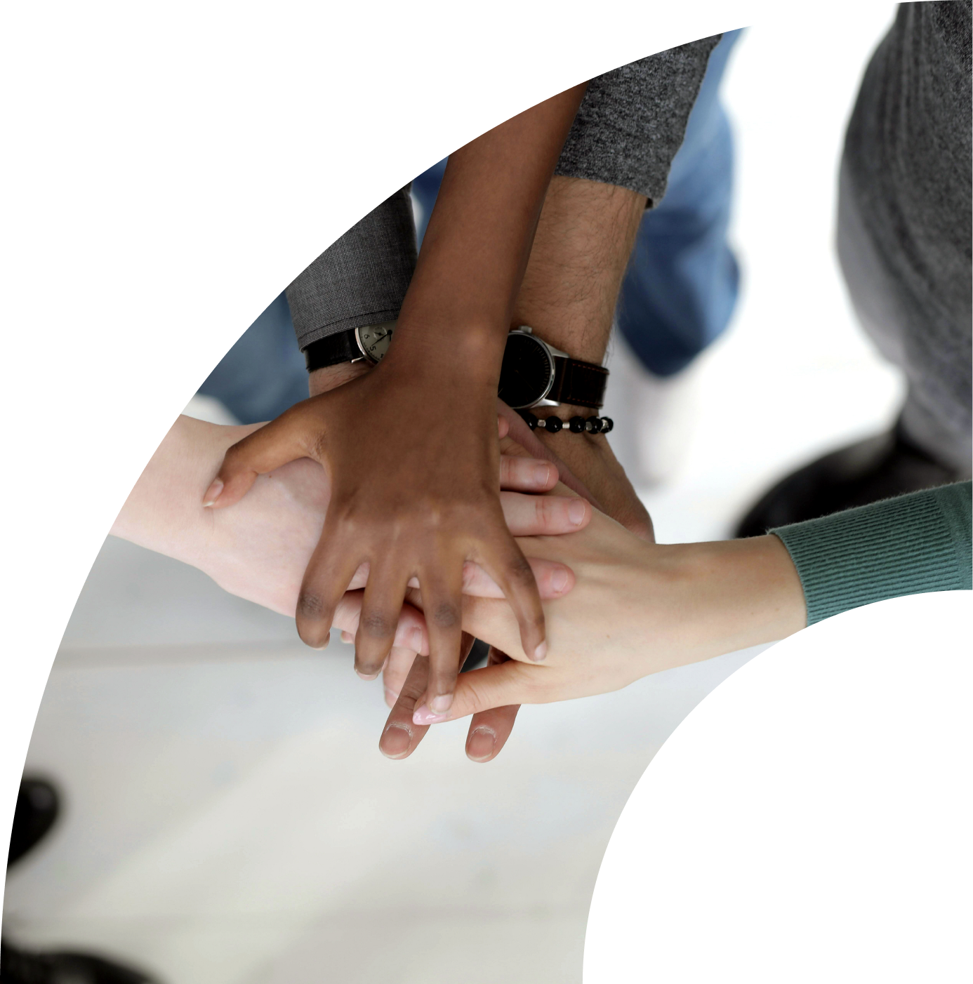 A diverse group of people placing their hands together.